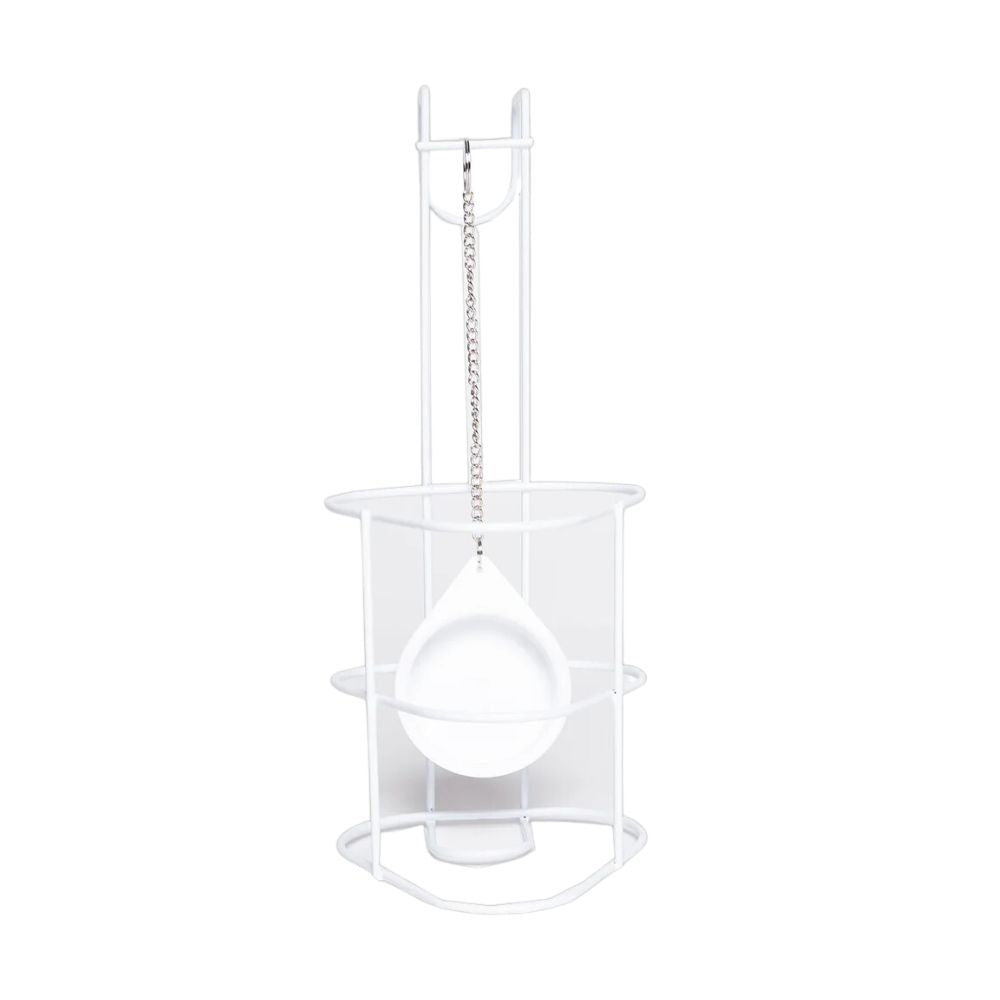 The white metal stand is a minimalist urine bottle holder from Meditrade GmbH, similar to a ladle holder with chain suspension. Its round base and vertical supports make it ideal for care beds, seamlessly combining form and function.