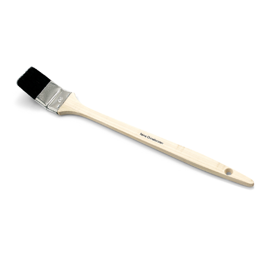 The Nölle Profi Brush Craftsman Radiator Brush features a wooden handle with a hole for easy storage, black China bristles, and a silver metal ferrule. The diagonal presentation on a white background emphasizes the craftsman quality.