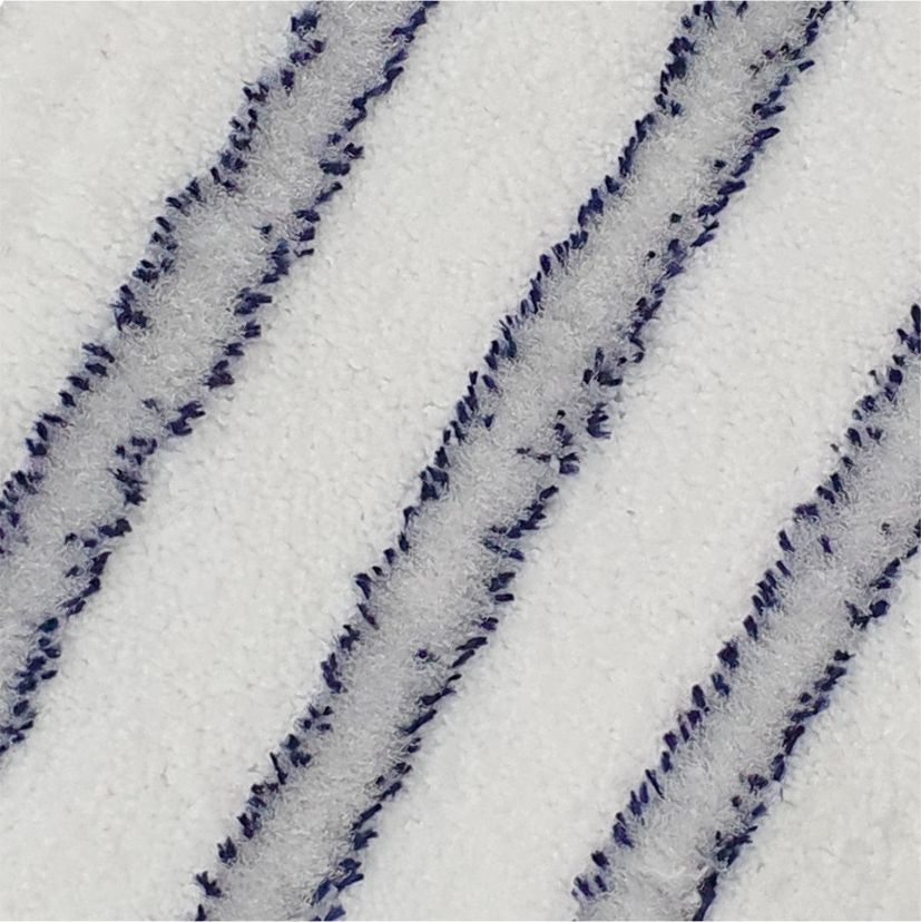 Close-up of the Arcora EXCELLENT SOFT MOPP BLUE-WHITE from Arcora International GmbH: On the white, textured surface, three evenly distributed, slightly raised diagonal lines in dark and light blue, soft fibers provide a high-quality finish.