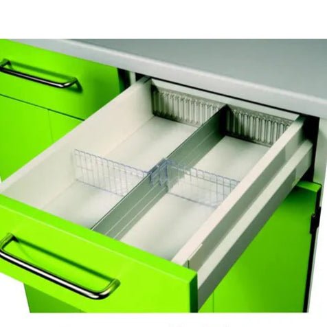 A green kitchen drawer with a metal handle opens, revealing a Novocal cross divider for drawer (170 mm), an adjustable white plastic organizer from Novocal, which is ideal for organizing drawers. The cabinet is green and the countertop is gray.