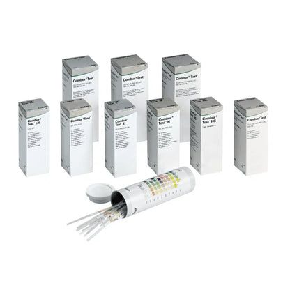 Behind an open cylindrical container with a lid are hidden nine boxes labeled "Combur®" by Servoprax GmbH, each containing 100 Roche urine test strips. On the side of the container is a multicolored chart, which is perfect for conducting a quick test.