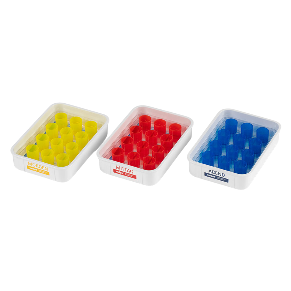 The SATZ melipul meal tray 12 VF-26 from Helmut Schwarz GmbH includes three pill dispensers with German color coding: "Morning" with yellow compartments, "Noon" with red compartments, and "Evening" with blue compartments. Each dispenser is equipped with a compartment grid to enable effective medication management.