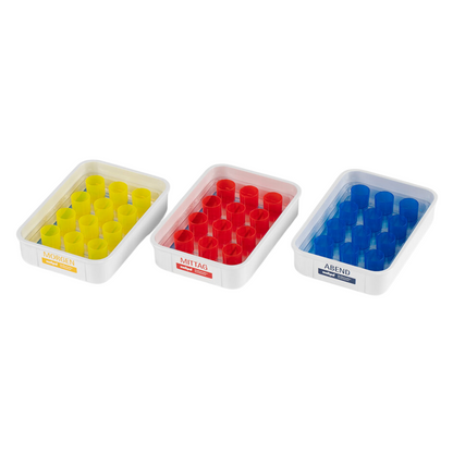The SATZ melipul meal tray 12 VF-26 from Helmut Schwarz GmbH includes three pill dispensers with German color coding: "Morning" with yellow compartments, "Noon" with red compartments, and "Evening" with blue compartments. Each dispenser is equipped with a compartment grid to enable effective medication management.
