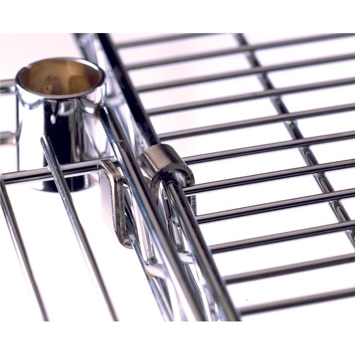 Close-up of a Novocal "S" hook for grid shelves (1 piece), securing chrome-gloss wire shelves; metal cylinder partially visible in the background. Ideal as a storage solution from Novocal.