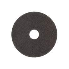 The Arcora SUPERPAD DARK BROWN from Arcora International GmbH is a round, flat, black scouring pad with a hole in the center and a rough texture, ideal for polishing dark surfaces with the polishing machine. Pictured against a white background.