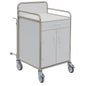 The Novocal station trolley made of stainless steel with all-around welded pipe connections, metal railings, drawer, double door cabinet, and four swivel casters is ideal for use in healthcare facilities.