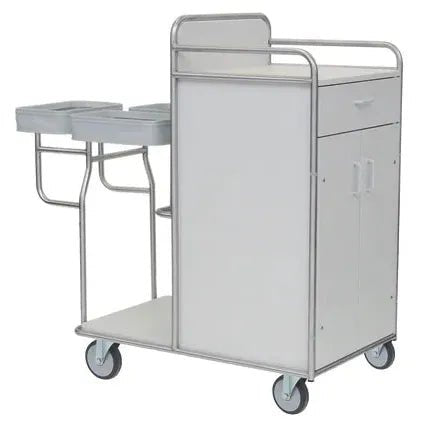 A Novocal station trolley made of stainless steel with fully welded tube connections, featuring two small shelves on the left side, a cabinet with hinged doors and an upper drawer, as well as four castors for easy mobility.