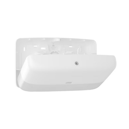 A white, rectangular wall unit from the TORK - Essity Professional Hygiene Germany GmbH series with a smooth, curved design. A logo is visible on the front and a sensor for easy activation is present. The model features a recessed area for efficient use.