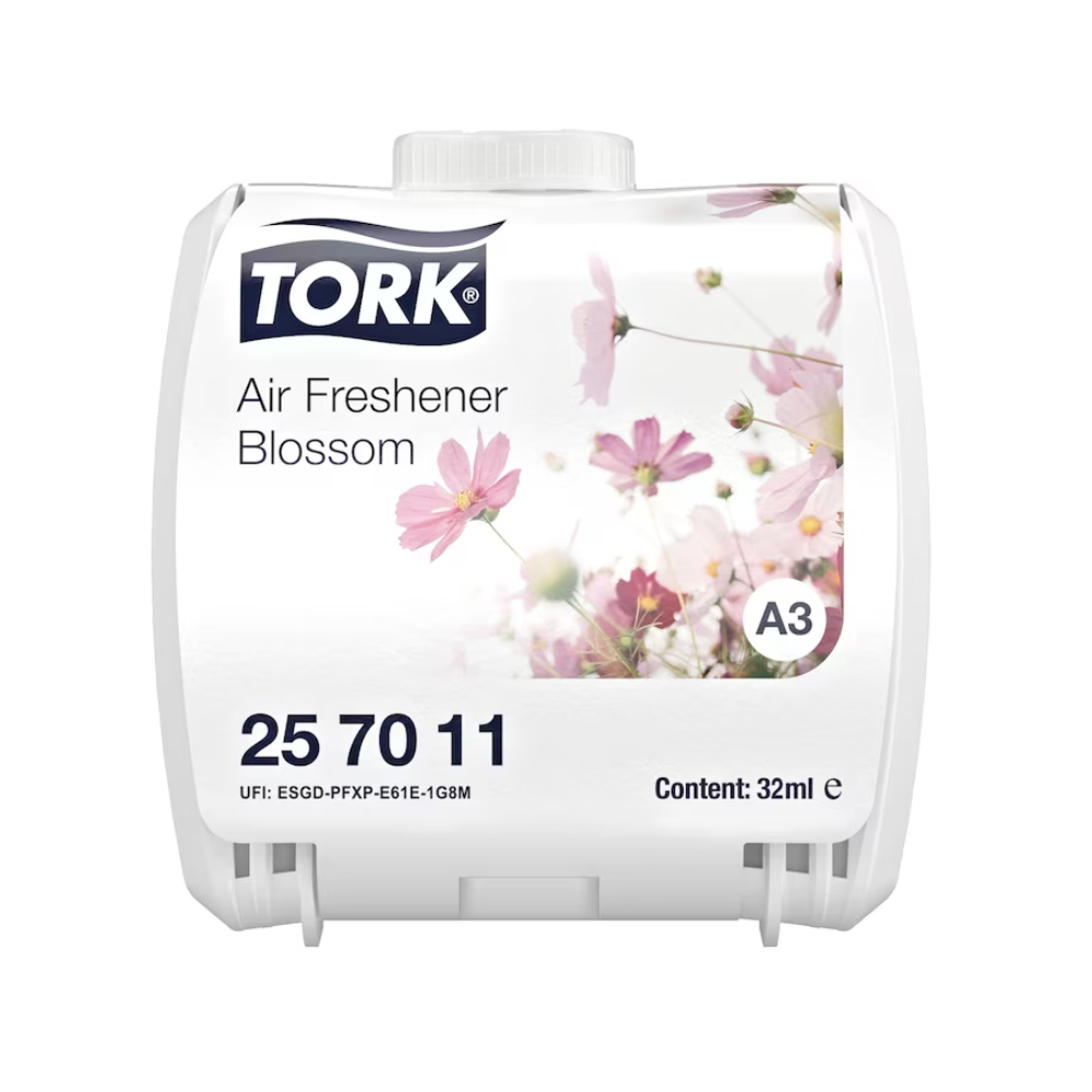 A white air freshener from TORK, known as "Continuous Air Freshener" with a floral design of pink and white flowers and the inscription "Air Freshener Blossom". The product has the code 25 70 11, is available in the size of 32 ml, and is equipped with a UFI code.