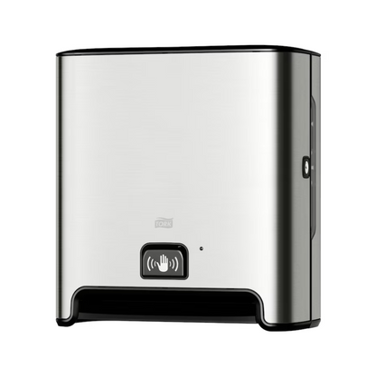 A TORK Tork Matic® 460001 sensor dispenser for roll towels Image Line made of stainless steel for wall mounting with sensor H1 | Pack (1 piece) with black base and sensor display symbol on the front. This dispenser, designed for touch-free single sheet dispensing, features a modern, simple appearance and uses roll towels to ensure a hygienic experience.