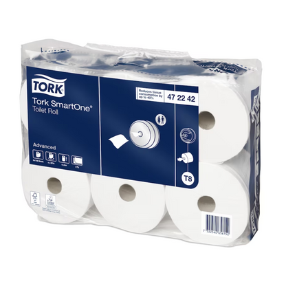 A carton of Tork SmartOne® toilet paper, designed for hygienic single sheet dispensing, is delivered in a transparent package revealing the six white rolls. The label shows product details in an elegant blue and white design by TORK – Essity Professional Hygiene Germany GmbH.