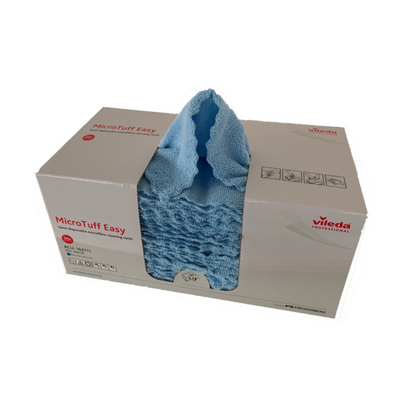 A box of Vileda Professional Micro Tuff Easy microfiber cloths in blue is displayed. The box is partially open, revealing several folded cloths. The packaging contains product information and symbols from Vileda GmbH.