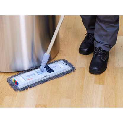 A person in black boots and gray pants is cleaning a light wooden floor with the Vileda Professional UltraSpeed Pro r-MicroSpeed Max Mop by Vileda GmbH, which features a 4D cleaning structure. The gray, fringed mop head glides smoothly, while on the left side of the image, a large stainless steel object is partially visible.
