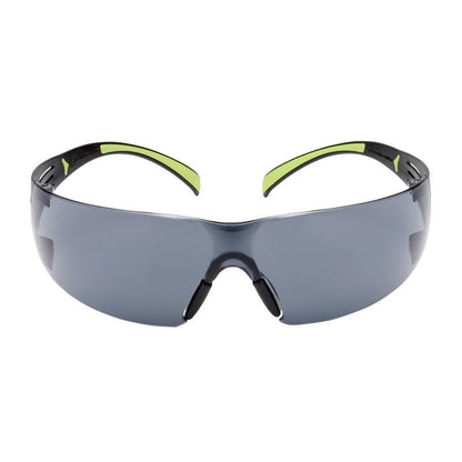 The 3M™ SecureFit™ Safety Glasses 400 from 3M Deutschland GmbH feature dark-tinted, wraparound lenses and black frames with green accents on the temples against a white background.