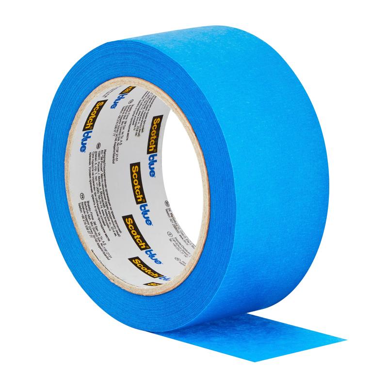 A roll of 3M Deutschland GmbH ScotchBlue™ Painter's Tape "Multi-Surface" is partially unrolled, with a blue strip protruding outward and the product name visible on the inner label.