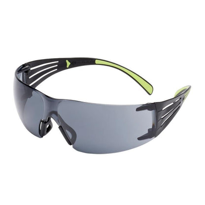 The 3M™ SecureFit™ Safety Glasses 400 from 3M Deutschland GmbH feature gray-tinted, wraparound lenses, a black frame, open side temples, and green accents on the temples and nose bridge, depicted against a white background.