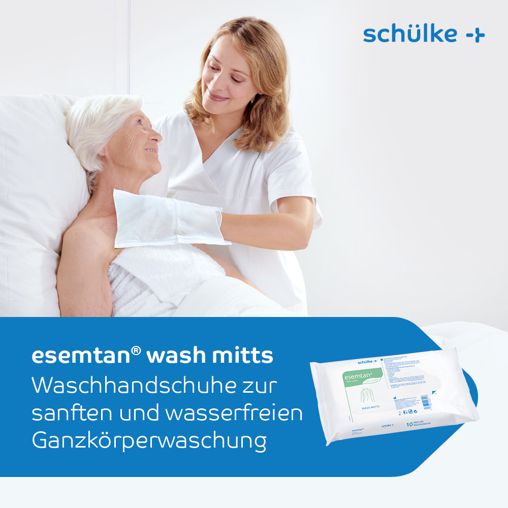A caregiver helps an elderly woman in a hospital bed. They use Schülke esemtan® wash gloves, 10-pack | Pack (10 gloves) for gentle, waterless full-body cleaning. In the foreground, the packaging of the wash gloves is visible. The text is in German.
